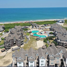 Aerial view of Barrier Island Station – 400 Building in foreground with close proximity to pool and beach access