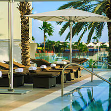 Renaissance Wind Creek Aruba - Ocean Suites — Pool Area With Loungers and Umbrellas