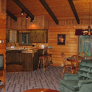 Glacier Wilderness Resort — Cabin kitchen, living, and dining areas