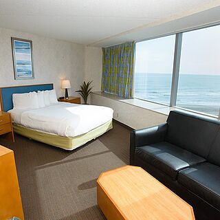 BoardWalk Resorts - Atlantic Palace &mdash; Queen bed and living area with sleeping sofa