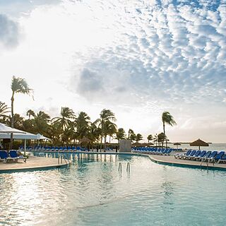 Renaissance Wind Creek Aruba - Ocean Suites — Pool Area With Loungers and Beach View