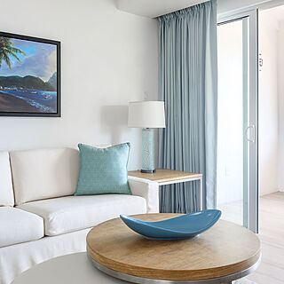 Representative one-bedroom villa living area with private balcony and ocean view